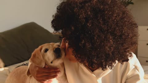 Woman kissing a dog