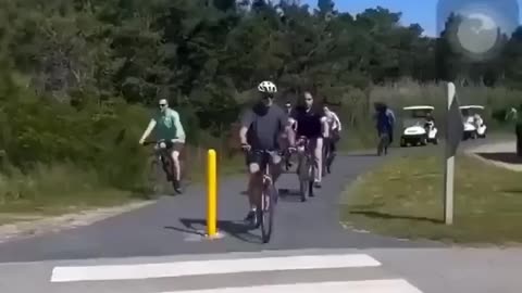 His shoe gets stuck in the toe clip, Joe Biden falls on his bike