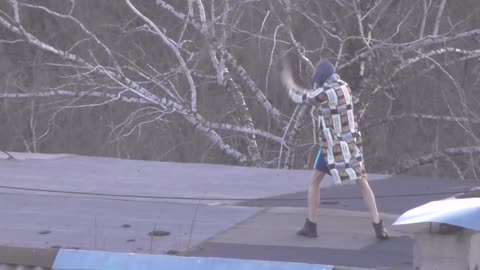 Man Practices His Martial Arts Skills on Rooftop