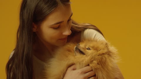 Woman holding cute puppy