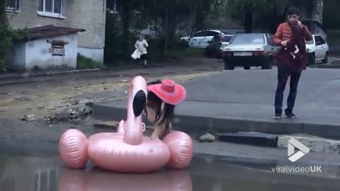 Just a girl on pink inflatable flamingo