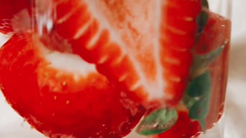 Sliced strawberry in water. Close view of Sliced strawberry