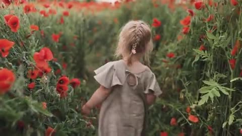 A little girl spinning among the tall flowers