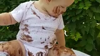 Dessert-loving baby completely covers herself in chocolate