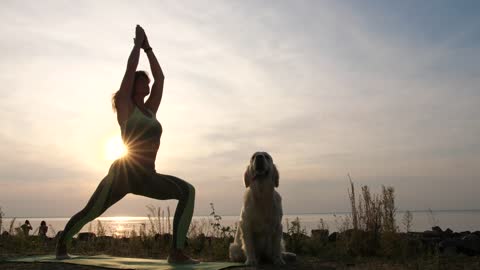 Woman doing Yoga at sunset