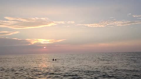 Relaxing in the sea at sunset