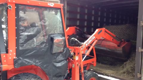 Part A Daniel pulling the round bale from the back of the box.