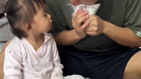 Dad accidentally sprays milk on daughter's face