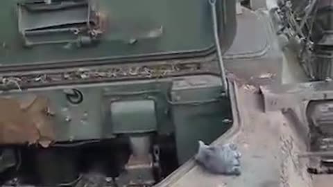 Russian Soldier Hosing His Buddies Out of a Damaged Vehicle