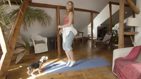 Woman exercising her dog watching him trying to copy him