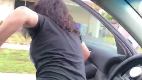 Girl in all black falls out of car on back