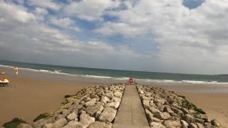 Drone footage panning away from the beach. Speedlapse