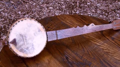 Red haired boy on gourd banjo