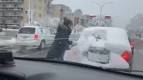 Cleaning Snow Off Stranger's Back Window