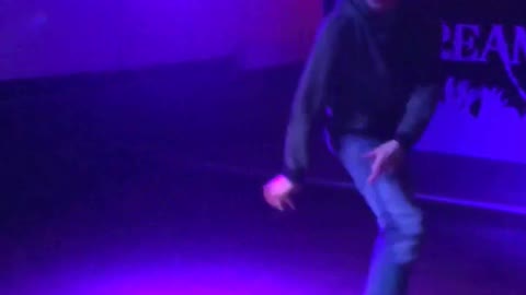 Man dancing by himself trips over own foot and falls in empty bar