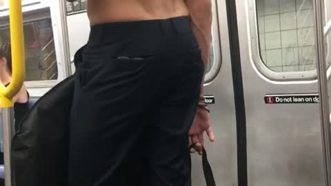 Shirtless man blue pants long hair