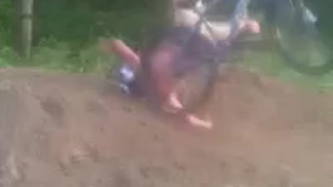 Shirtless red helmet mountain bike fall