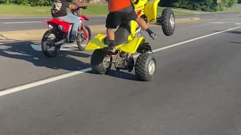 Man on Yellow Four-Wheeler Pulls Impressive Stunts