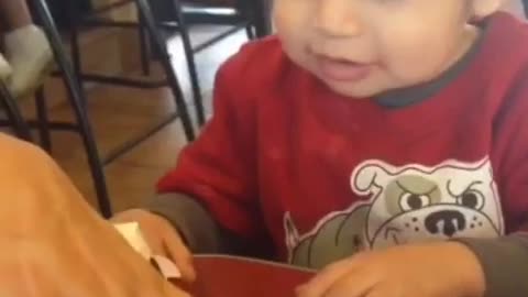 Lunch time and you know it red shirt kid reacts happily to chicken nuggets