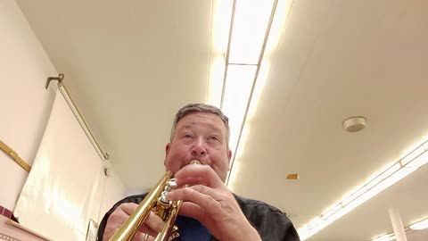 Checking out an old trumpet when a student walks in.