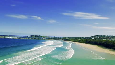 A Beautiful View Of A Beach With Blue Waters