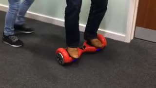 Man in red hover board pushed and falls