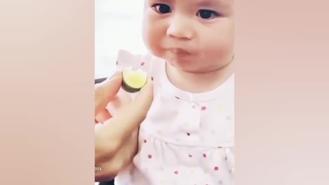 The baby 👶 eat lemon 🍋. Or she giving a cute face expression.