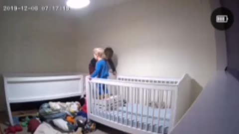 Boy Helps Brother out of Crib