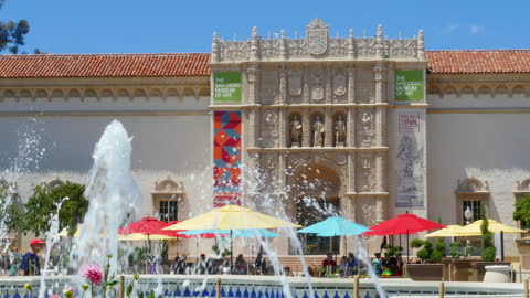 California Fountain With Pink Flowers And People