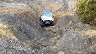 Jeep Driving Up Steep Slope