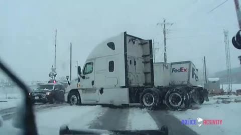 Police Dashcam Footage Captures Train Crashing Into FedEx Truck