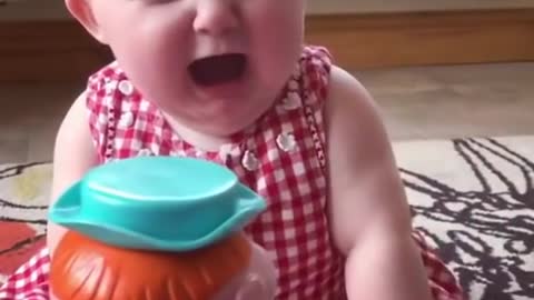 Funny laughing baby scared by gift toy - baby laughing