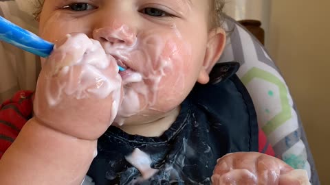 Happy Baby Makes a Mess Eating Yogurt