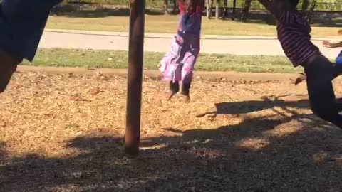 Large Group of Kids Spinning around on Playground Equipment