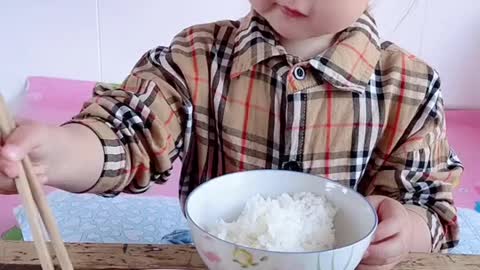 Cute baby eating in food