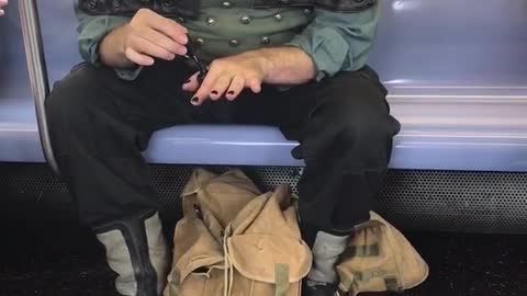 Man dressed as pirate doing nails on subway