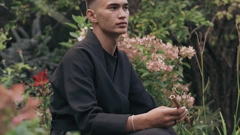 The boy is relaxing in a forest