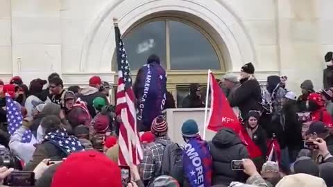 You can hear the crowd booing and demanding this person stop breaking the window at the Capitol