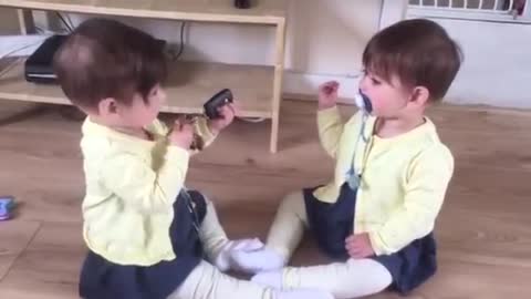 Twin baby girls fighting for car keys