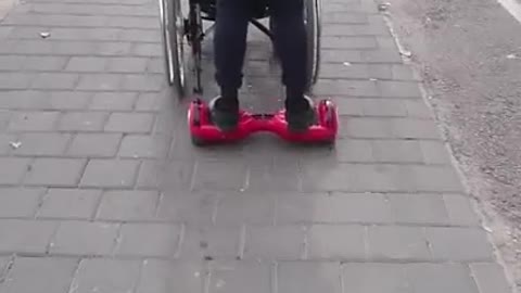 Hoverboarding whilst pushing a guy in a wheelchair