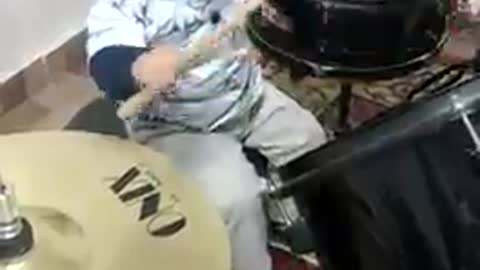 baby playing drums