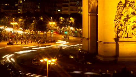 Night roundabout with fast-motion traffic