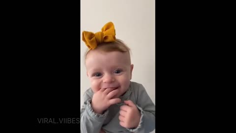 Adorable baby girl shows off her bow collection