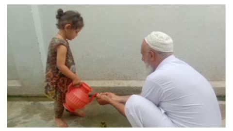 Muslim girl helping grandfather.