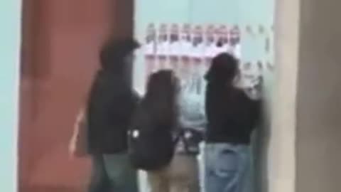 Students at New York university rip down posters of the missing people that Hamas took hostage