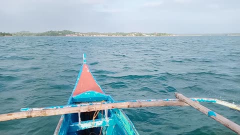 SMALL BOAT ACROSS ROUGH SEA