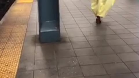 Uhh person in purple mask and costume dancing on platform