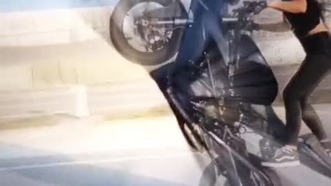 Beautiful girl stunt a bike