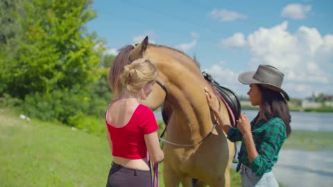 Positive african female rider in stylish clothes and cowboy hat learning