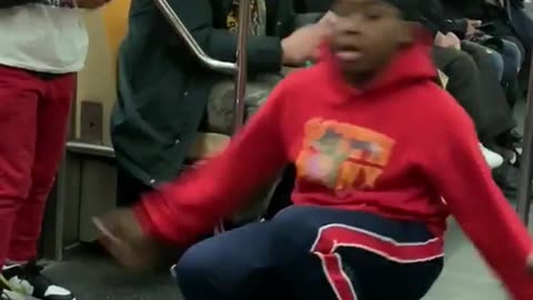 Two kids breakdance on a subway train to marc anthony's "i need to know"